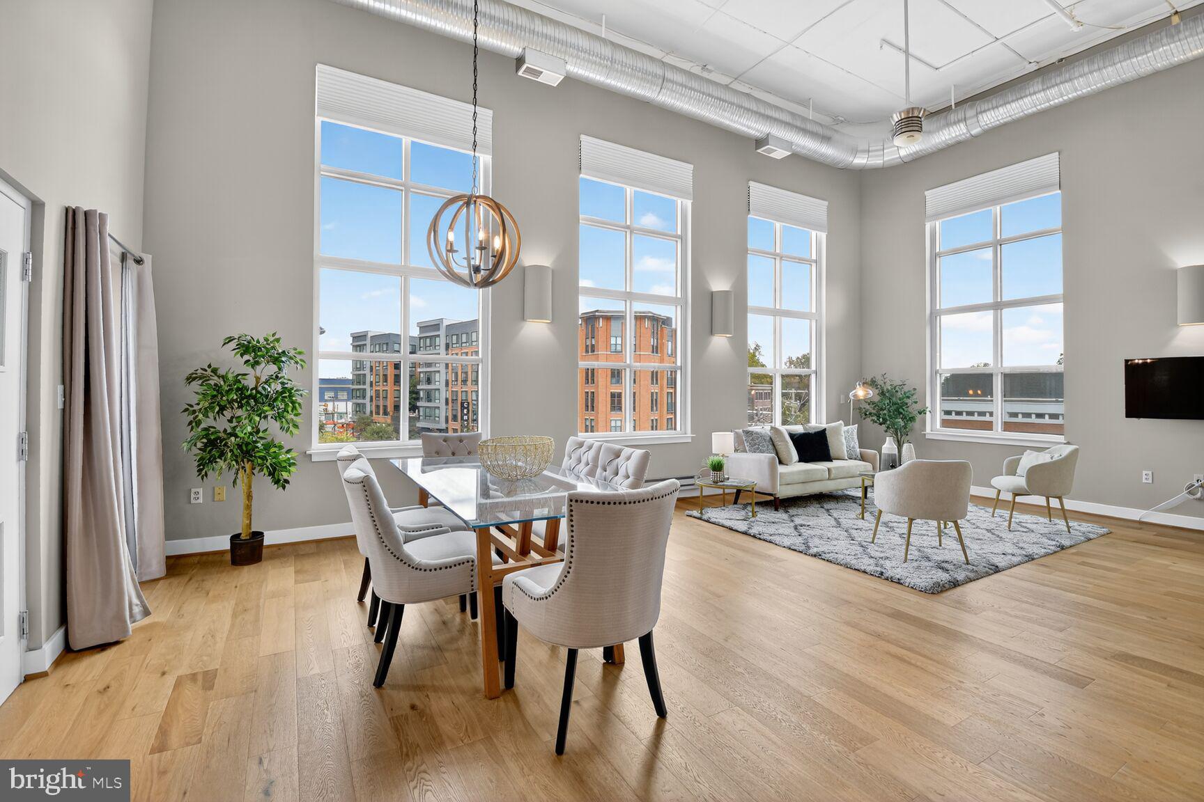 900 Bonifant Street, Unit D Silver Spring, MD 20910 - Photo 5 of 54 a dining room with wooden floor a chandelier a glass table and chairs