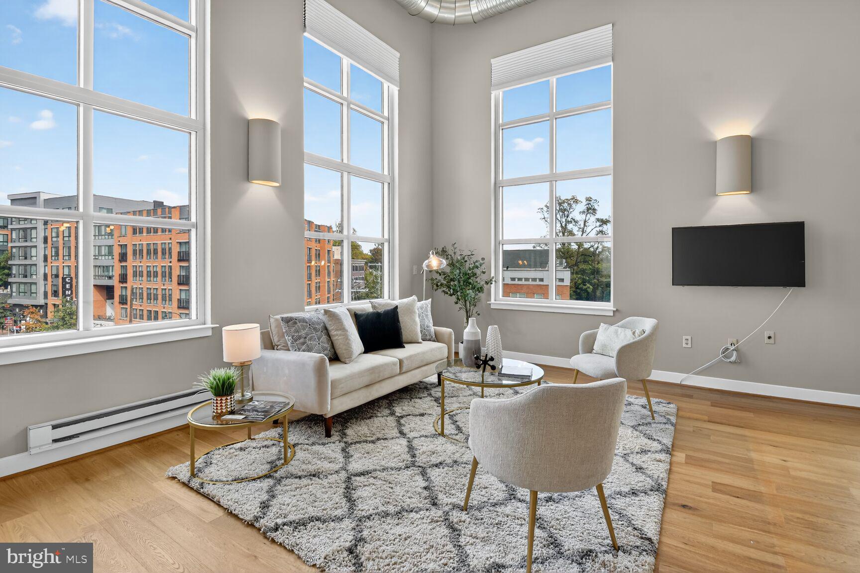 900 Bonifant Street, Unit D Silver Spring, MD 20910 - Photo 6 of 54 a living room with furniture a flat screen tv and a large window