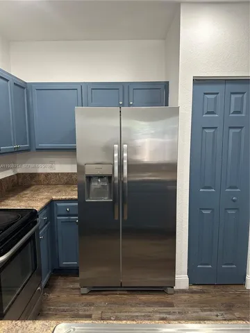 a kitchen with a refrigerator and a sink