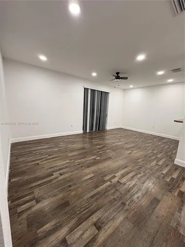 an empty room with wooden floor
