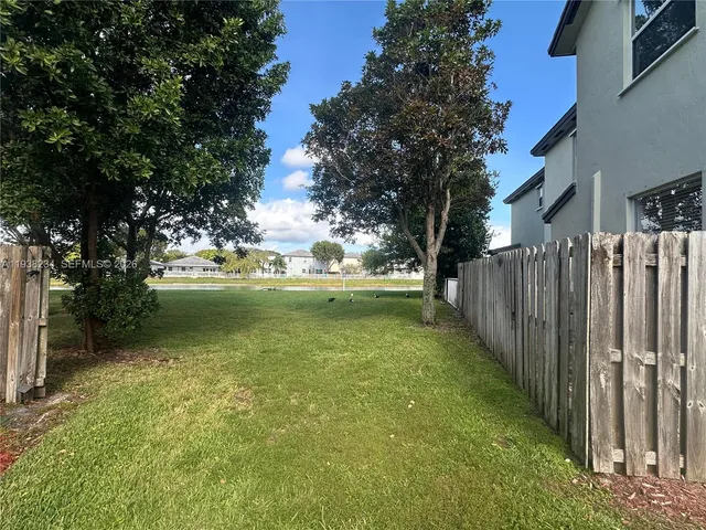 a view of a garden with wooden fence