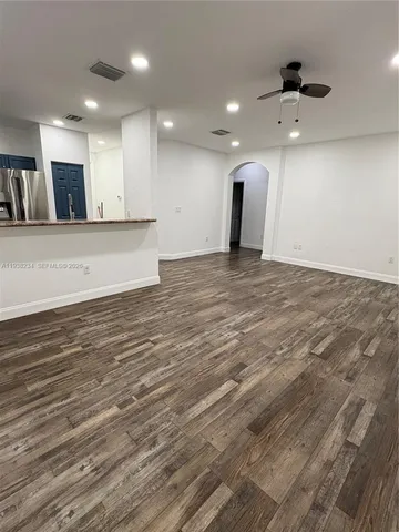 a view of an empty room with kitchen appliances