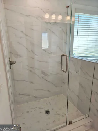 a bathroom with a glass shower door