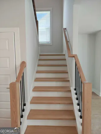 a view of staircase with wooden floor and a window
