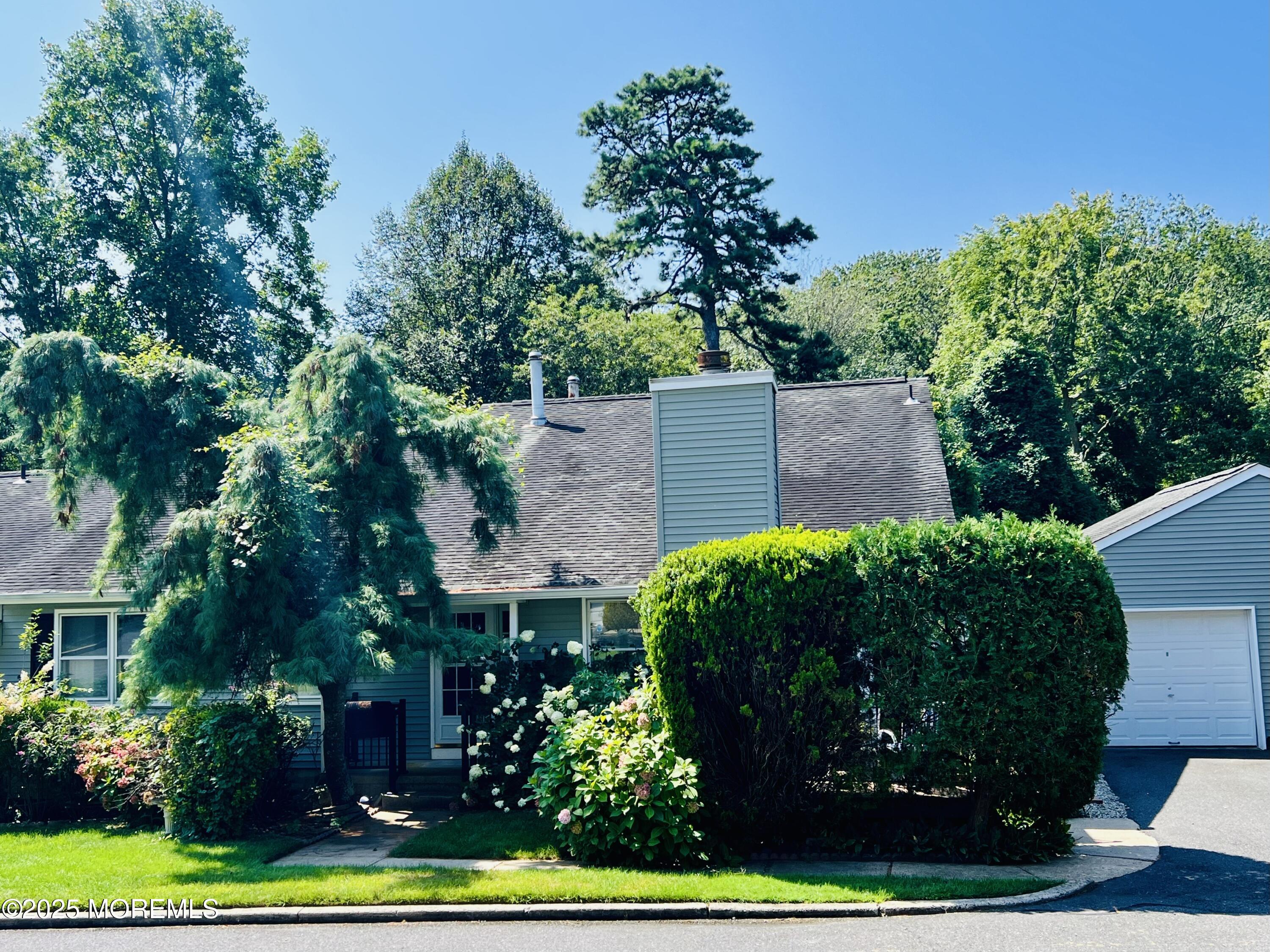29 Mulberry Court, Unit D Brielle, NJ 08730 - Photo 5 of 22 front view of a house with a garden