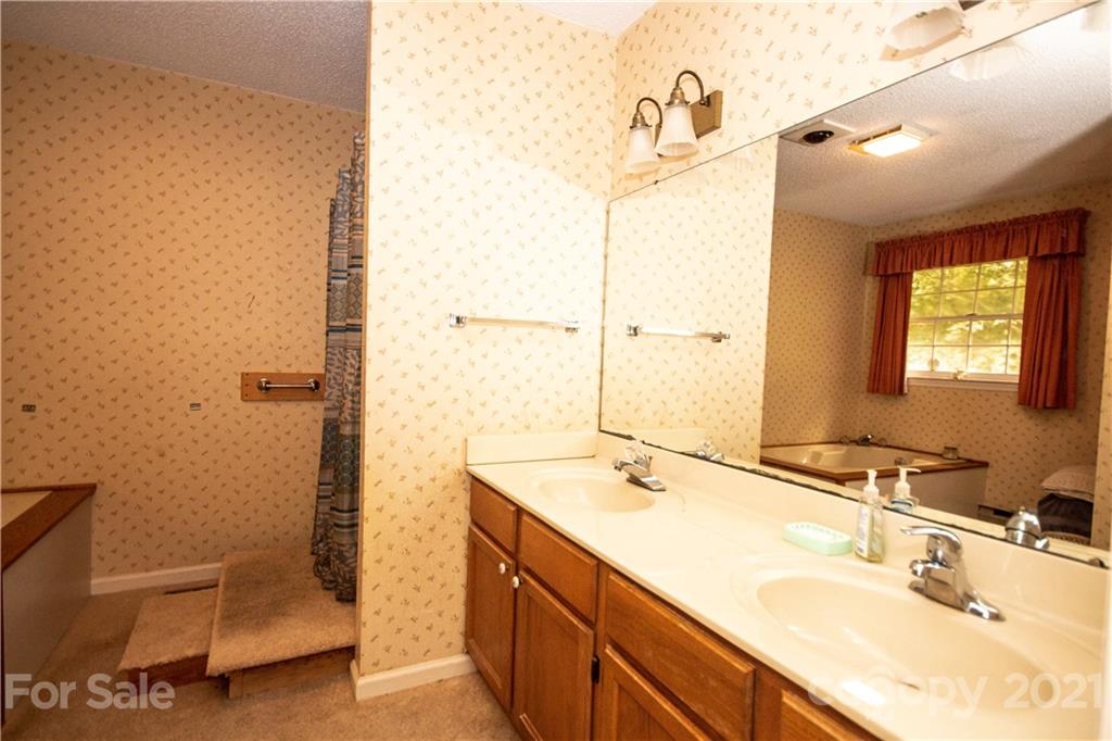 449 Oak Ridge Drive Clyde, NC 28721 - Photo 11 of 18 a bathroom with a sink and a mirror