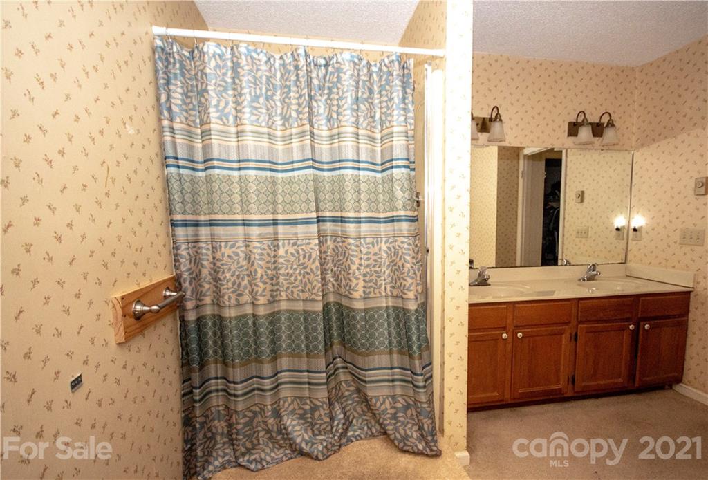 449 Oak Ridge Drive Clyde, NC 28721 - Photo 12 of 18 a bathroom with a shower and a sink