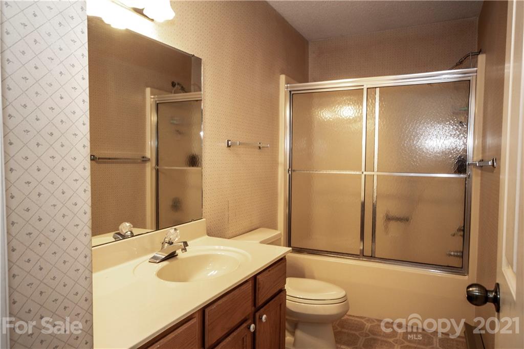 449 Oak Ridge Drive Clyde, NC 28721 - Photo 15 of 18 a bathroom with a sink toilet and shower