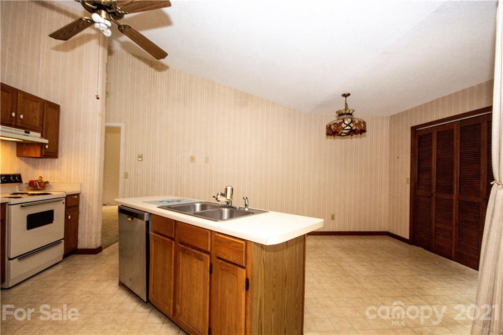449 Oak Ridge Drive Clyde, NC 28721 - Photo 5 of 18 a kitchen with a sink a stove and a microwave
