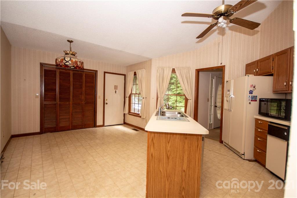 449 Oak Ridge Drive Clyde, NC 28721 - Photo 6 of 18 a view of a kitchen with a sink and a refrigerator