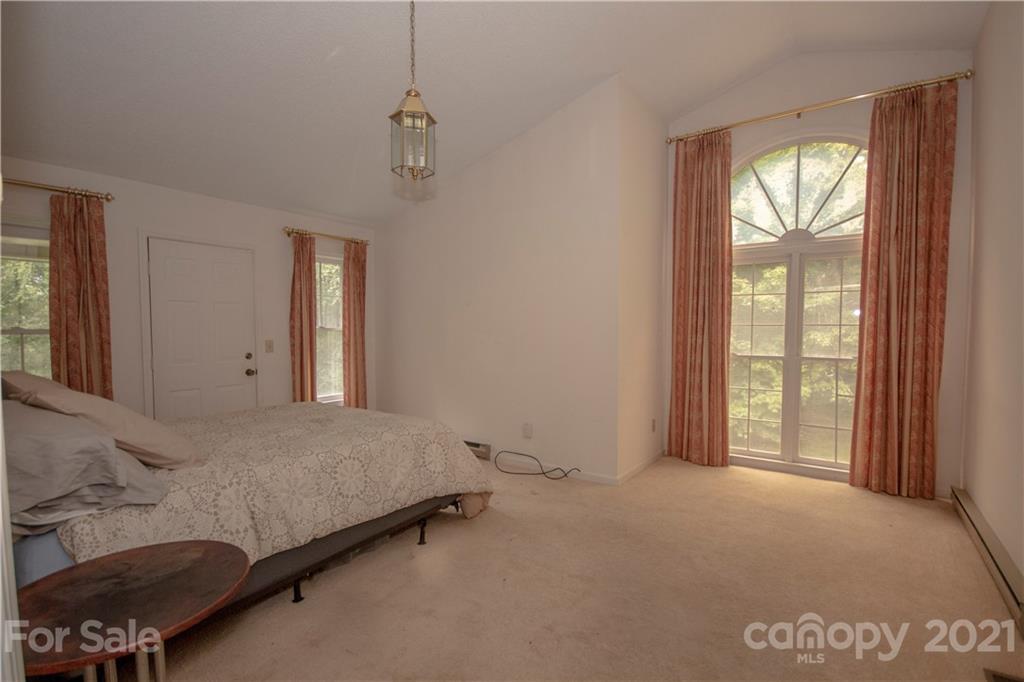 449 Oak Ridge Drive Clyde, NC 28721 - Photo 10 of 18 a bedroom with a bed and a window