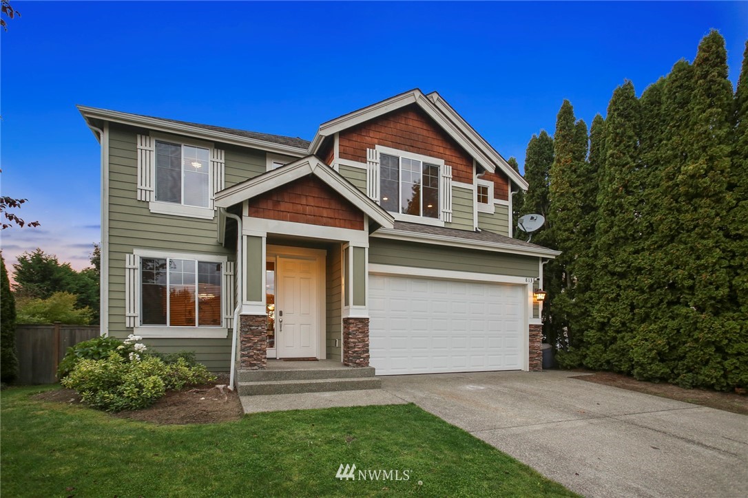 813 Field Avenue Northeast Renton, WA 98059 - Photo 1 of 22 a front view of a house with a garden