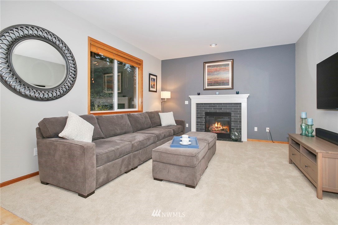 813 Field Avenue Northeast Renton, WA 98059 - Photo 11 of 22 a living room with furniture a fireplace and a flat screen tv