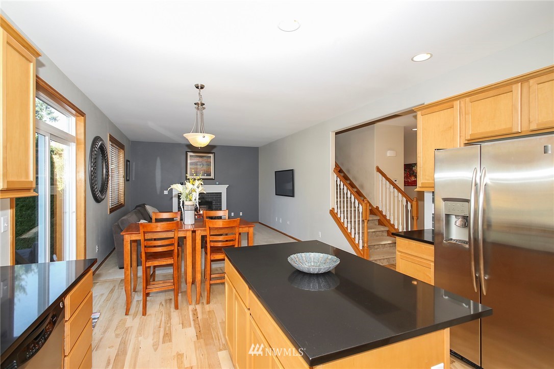 813 Field Avenue Northeast Renton, WA 98059 - Photo 10 of 22 a dining room with wooden floor and stainless steel appliances