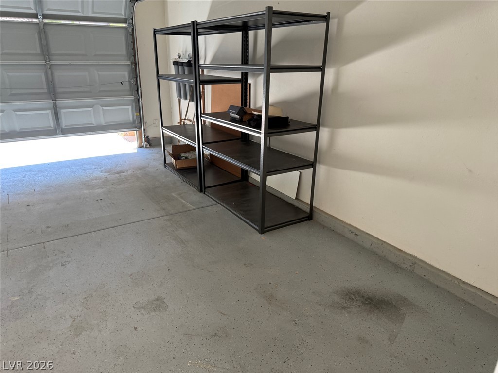 1141 Cathedral Ridge Street Henderson, NV 89052 - Photo 67 of 77 This spacious garage offers practical storage solutions with its durable shelving units.