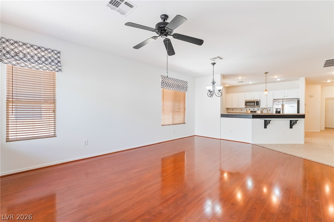 5389 Progresso Street Las Vegas, NV 89135 - Photo 16 of 41 Rich hardwood floors unite an open-concept living space with a well-appointed kitchen.