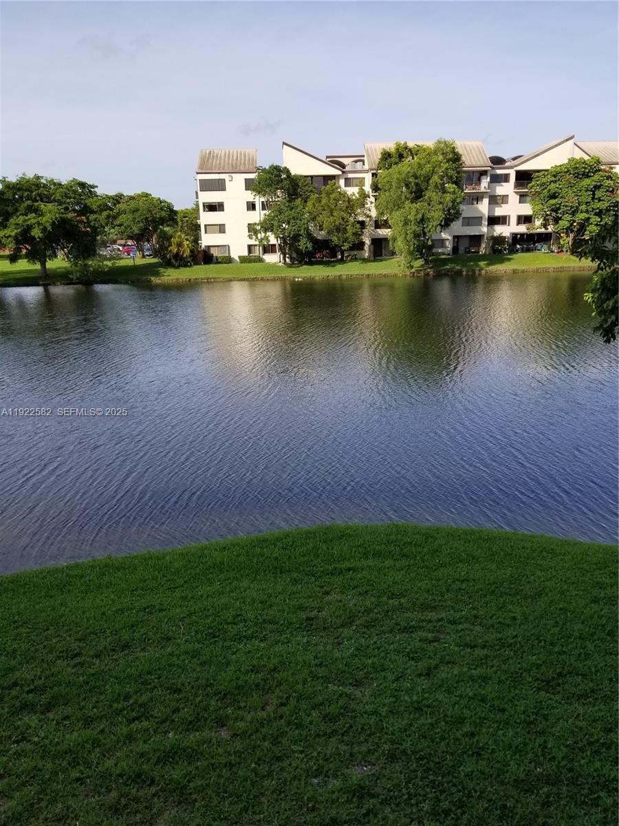 6701 Southwest 116th Court, Unit 203 Miami, FL 33173 - Photo 1 of 12 an aerial view of residential houses with outdoor space and lake view