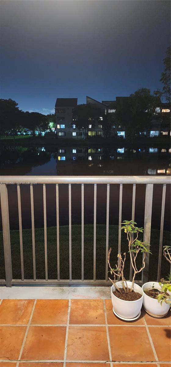 6701 Southwest 116th Court, Unit 203 Miami, FL 33173 - Photo 5 of 12 a view of a balcony with chairs and potted plants