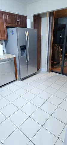 a kitchen with granite countertop a stove a sink and a microwave