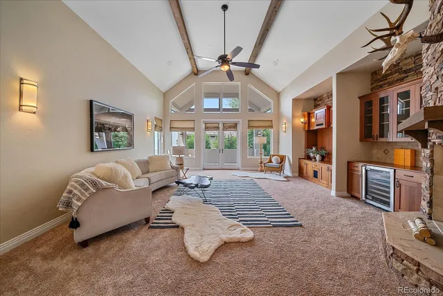 a living room with furniture a fireplace and a chandelier