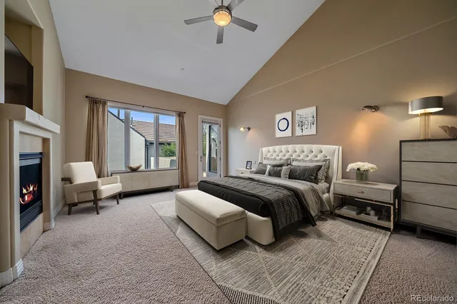 a spacious bedroom with a bed couch and a window