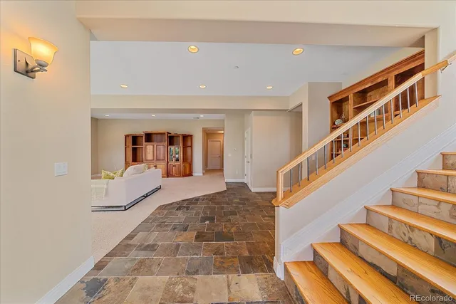 a view of staircase with white walls and a rug