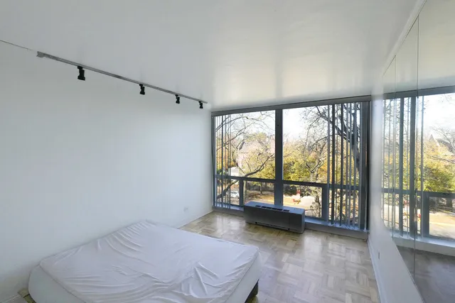 a bedroom with a bed and a shower