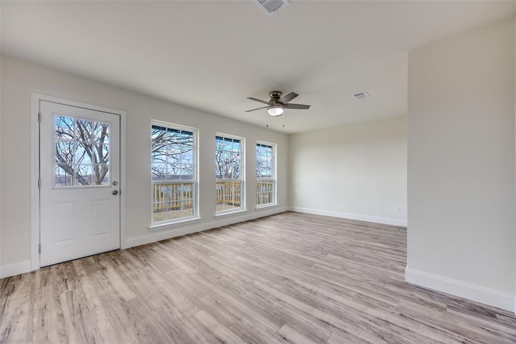 471 Meadowview Circle Van Alstyne, TX 75495 - Photo 14 of 39 a view of an empty room with a window and wooden floor