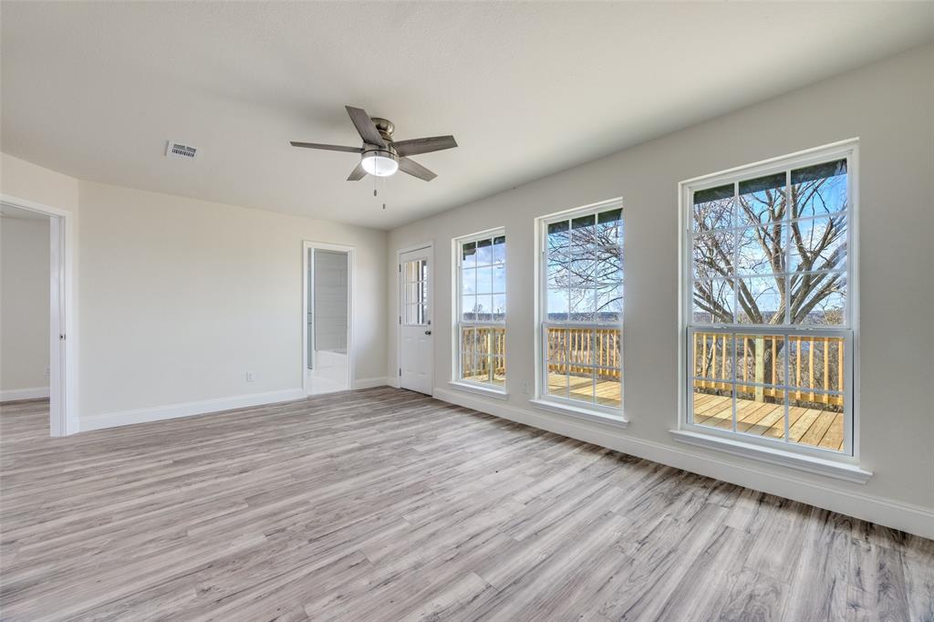 471 Meadowview Circle Van Alstyne, TX 75495 - Photo 15 of 39 a view of an empty room with a window and wooden floor