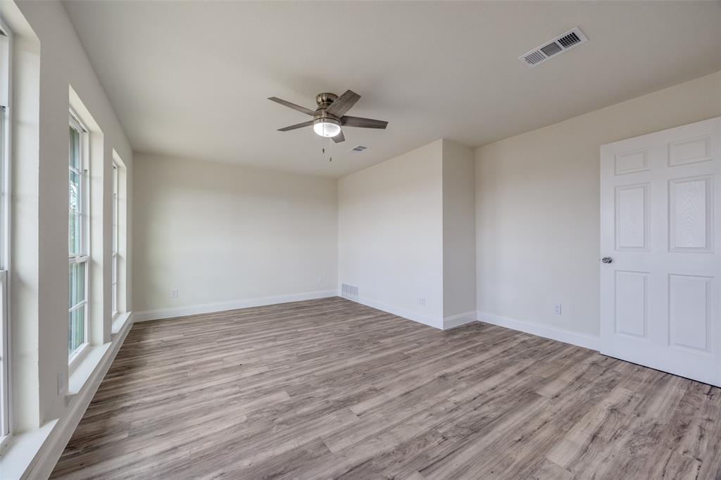 471 Meadowview Circle Van Alstyne, TX 75495 - Photo 17 of 39 a view of empty room with wooden floor and fan