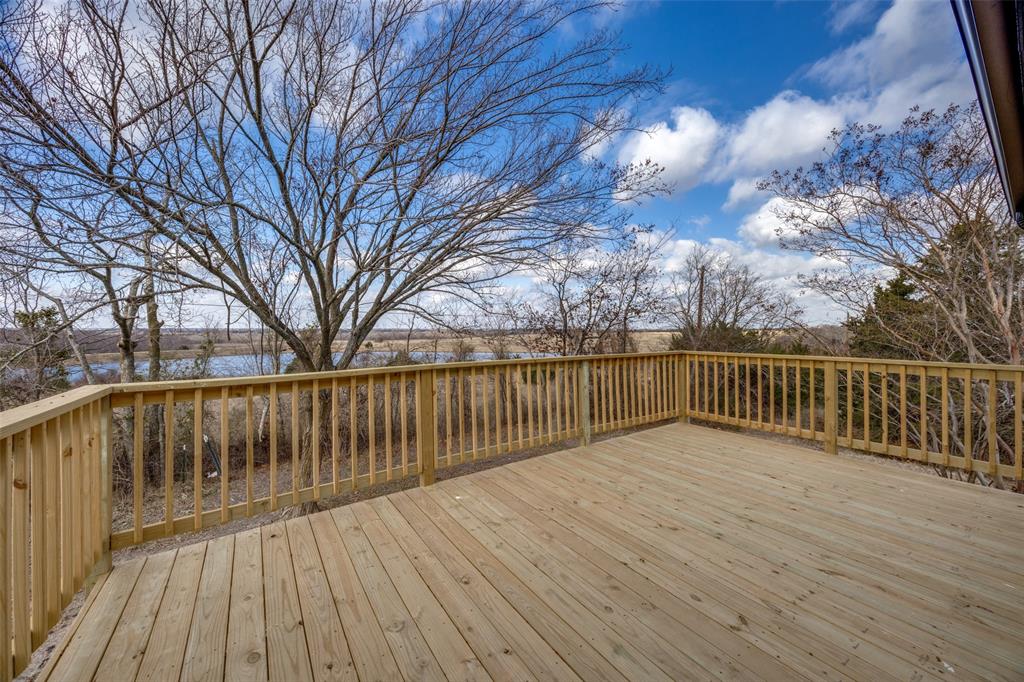 471 Meadowview Circle Van Alstyne, TX 75495 - Photo 20 of 39 a view of deck with wooden floor and fence with large trees