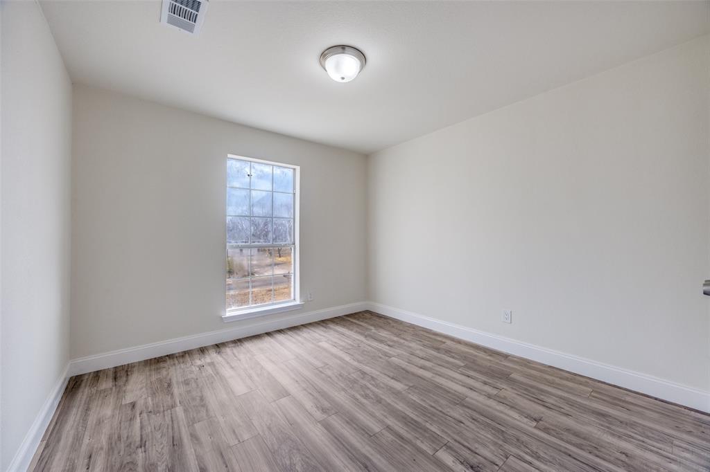 471 Meadowview Circle Van Alstyne, TX 75495 - Photo 24 of 39 an empty room with wooden floor and windows