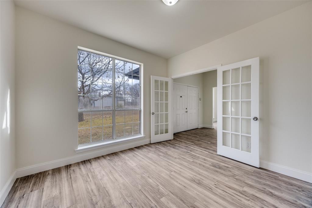 471 Meadowview Circle Van Alstyne, TX 75495 - Photo 3 of 39 an empty room with wooden floor and windows