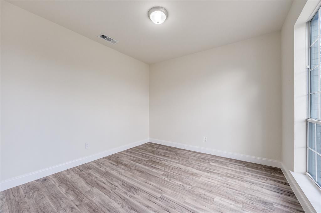 471 Meadowview Circle Van Alstyne, TX 75495 - Photo 31 of 39 an empty room with wooden floor and windows
