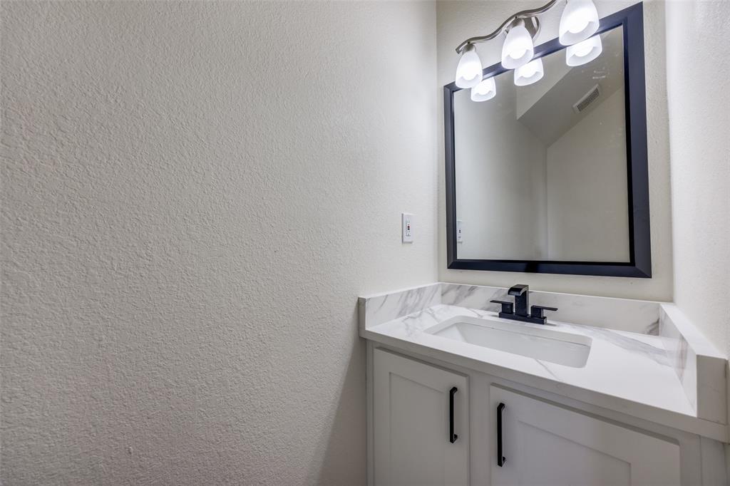 471 Meadowview Circle Van Alstyne, TX 75495 - Photo 6 of 39 a bathroom with a sink vanity and a mirror
