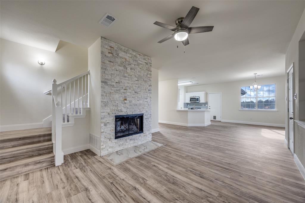 471 Meadowview Circle Van Alstyne, TX 75495 - Photo 10 of 39 wooden floor fireplace and natural light in room