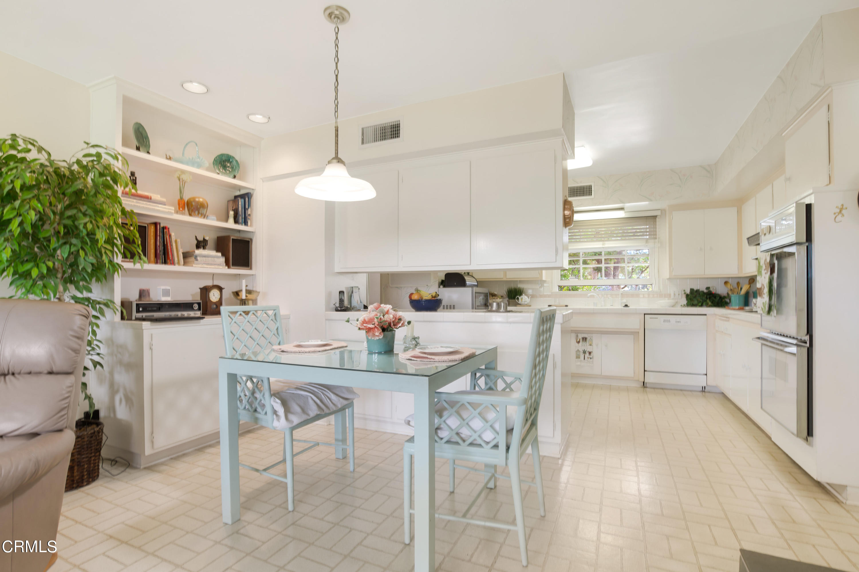 1387 Fairway Drive Camarillo, CA 93010 - Photo 19 of 51 a kitchen with kitchen island a dining table chairs stainless steel appliances and cabinets