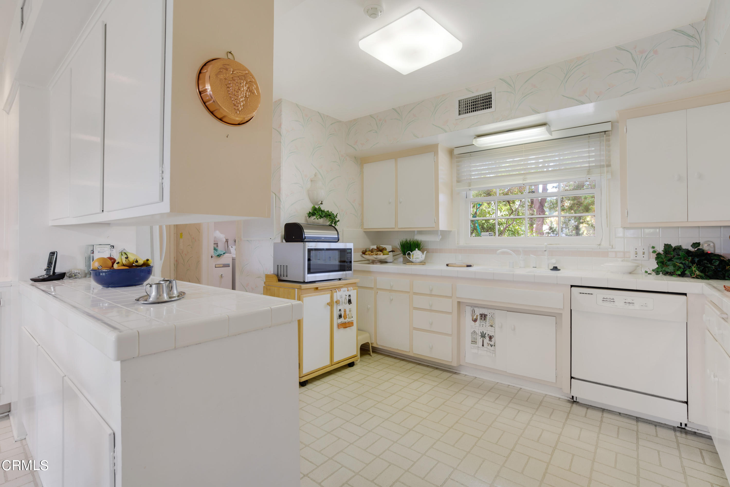 1387 Fairway Drive Camarillo, CA 93010 - Photo 20 of 51 a kitchen with cabinets appliances a sink and a window
