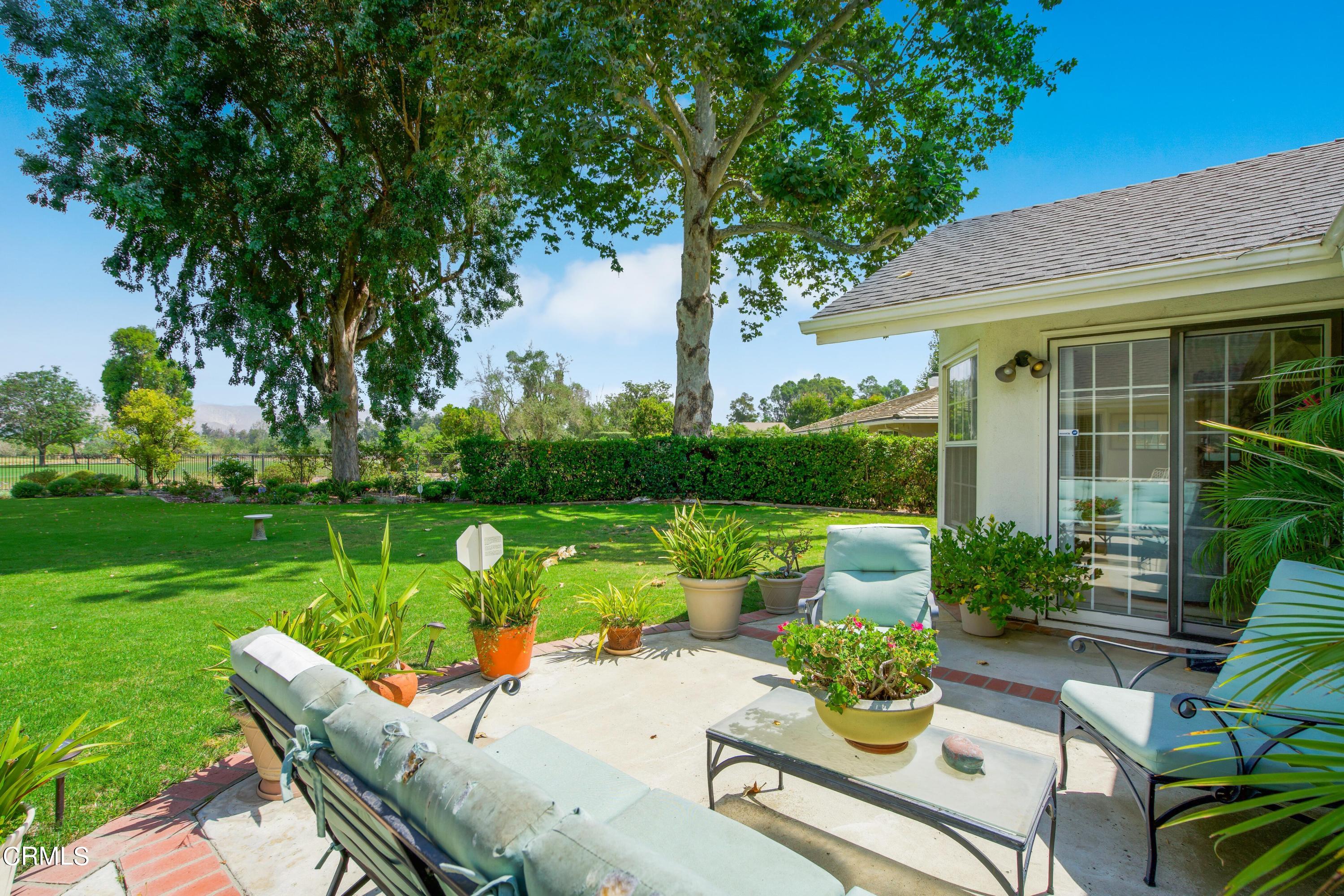 1387 Fairway Drive Camarillo, CA 93010 - Photo 33 of 51 a view of a patio with couches table and chairs under an umbrella with large trees