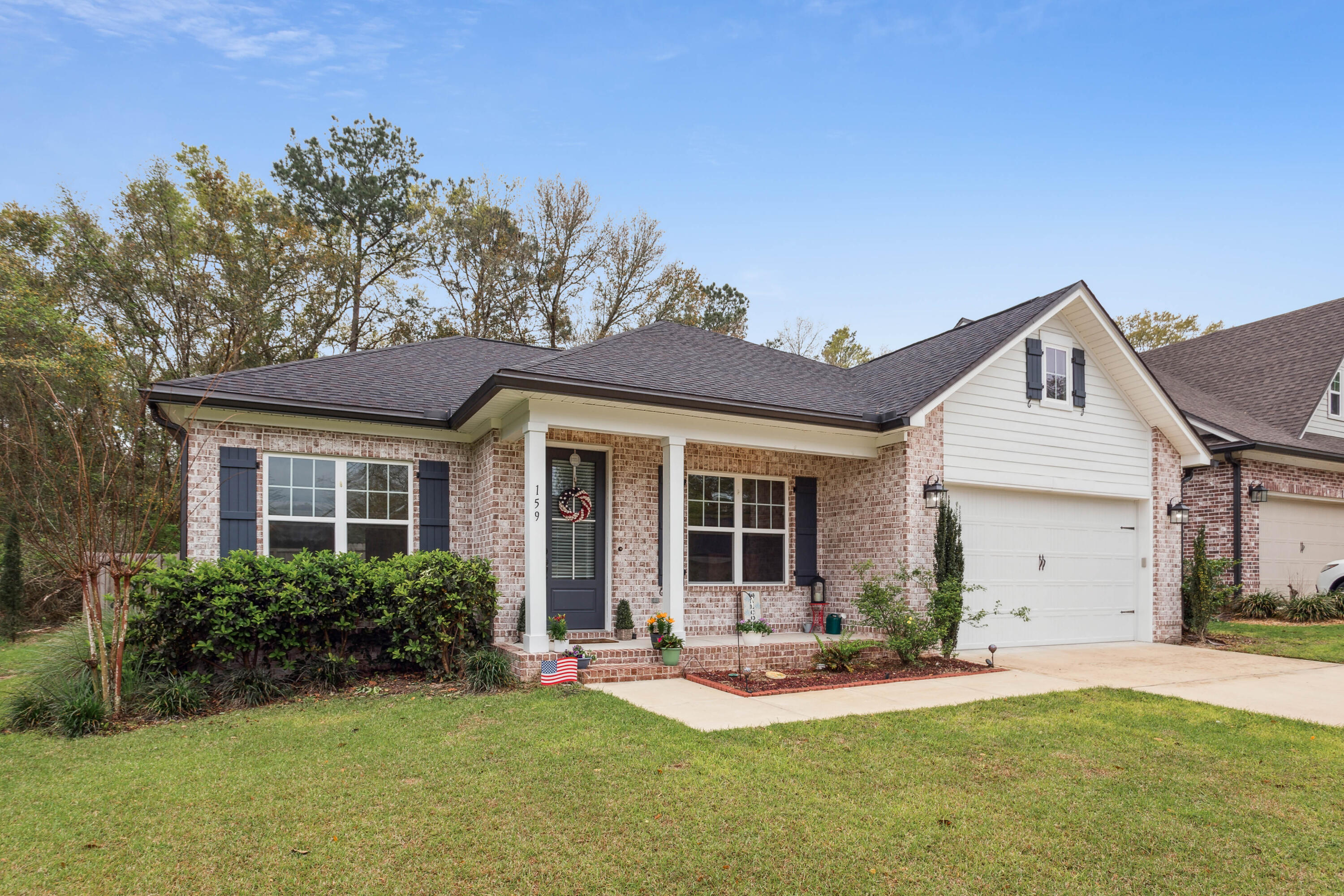 a front view of a house with a yard and outdoor seating