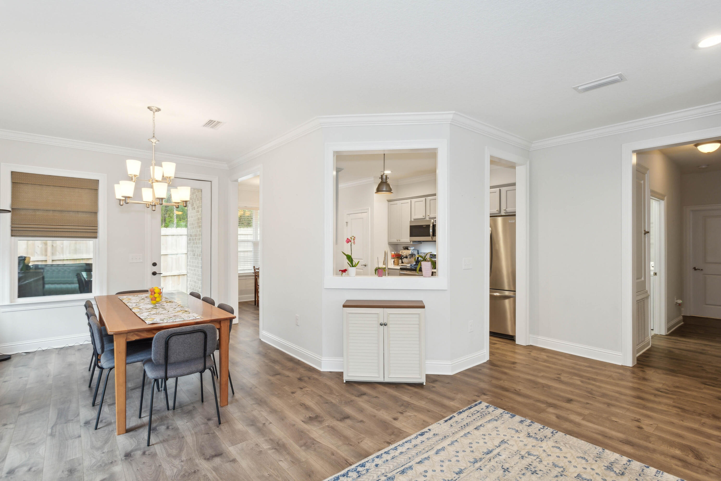 159 Laurel Oaks Drive Freeport, FL 32439 - Photo 11 of 34 a view of a dining room with furniture and wooden floor