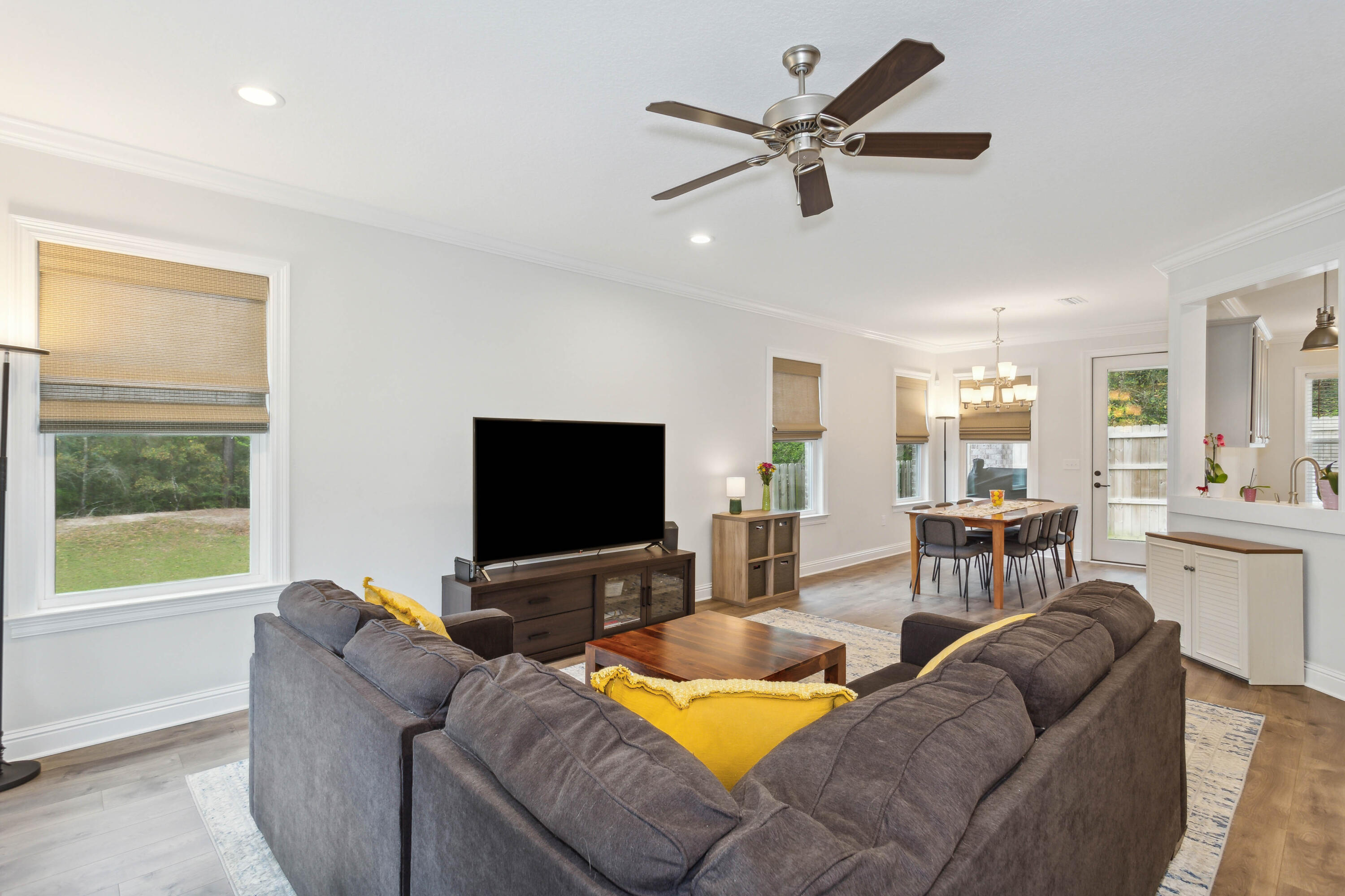 159 Laurel Oaks Drive Freeport, FL 32439 - Photo 16 of 34 a living room with furniture and a flat screen tv with wooden floor