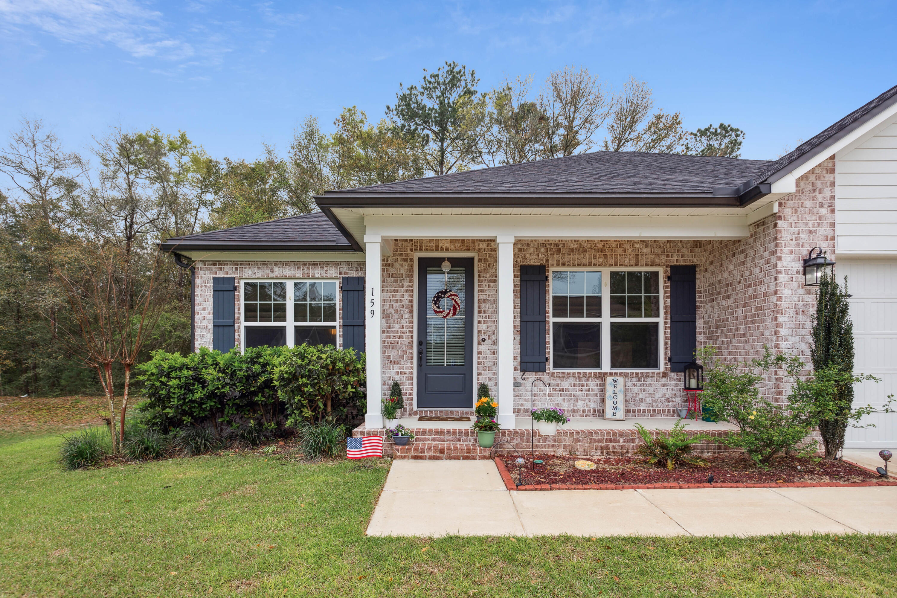 159 Laurel Oaks Drive Freeport, FL 32439 - Photo 3 of 34 front view of a house with a yard