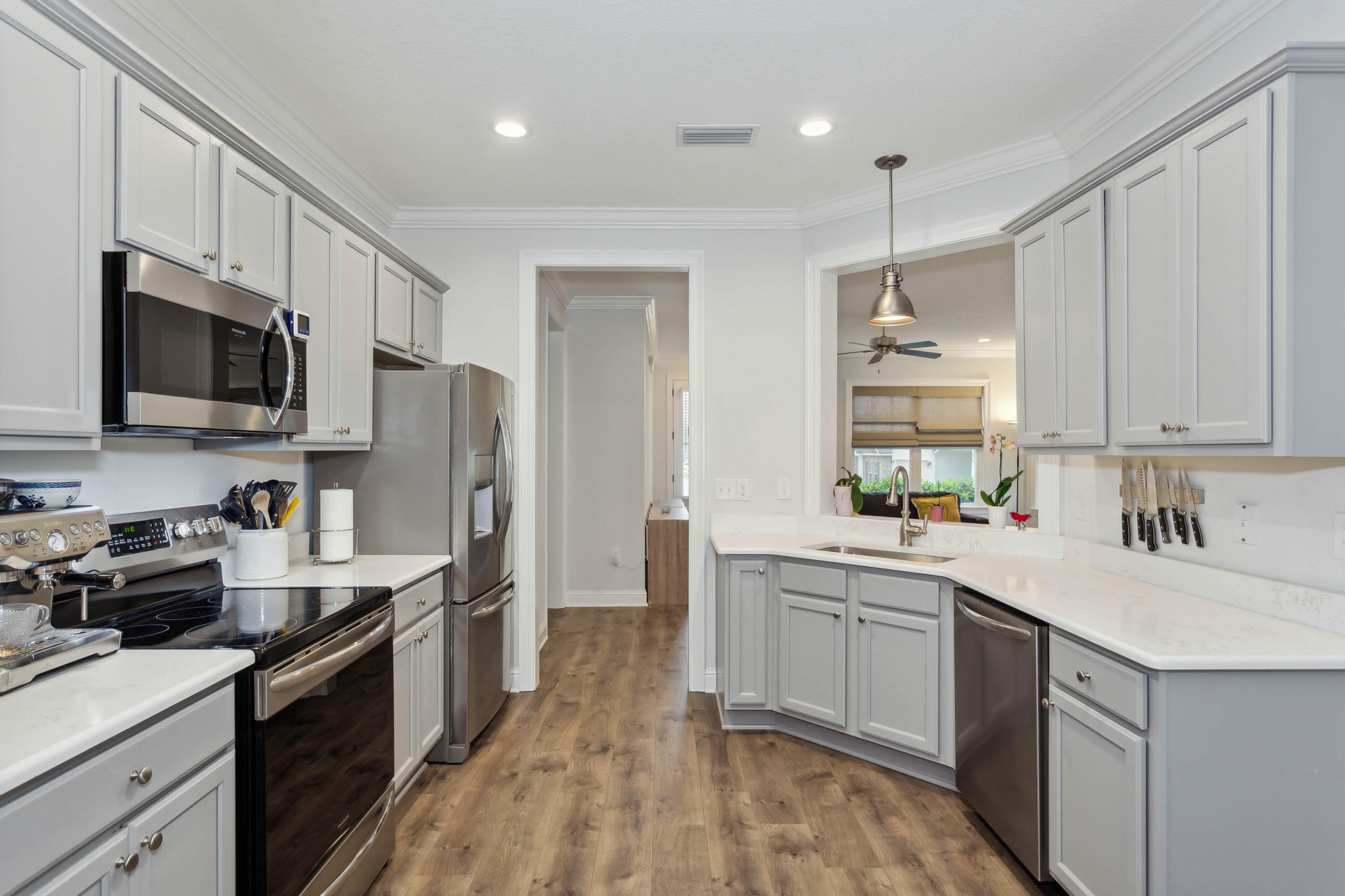 159 Laurel Oaks Drive Freeport, FL 32439 - Photo 5 of 34 a kitchen with a sink a counter top space stainless steel appliances and cabinets