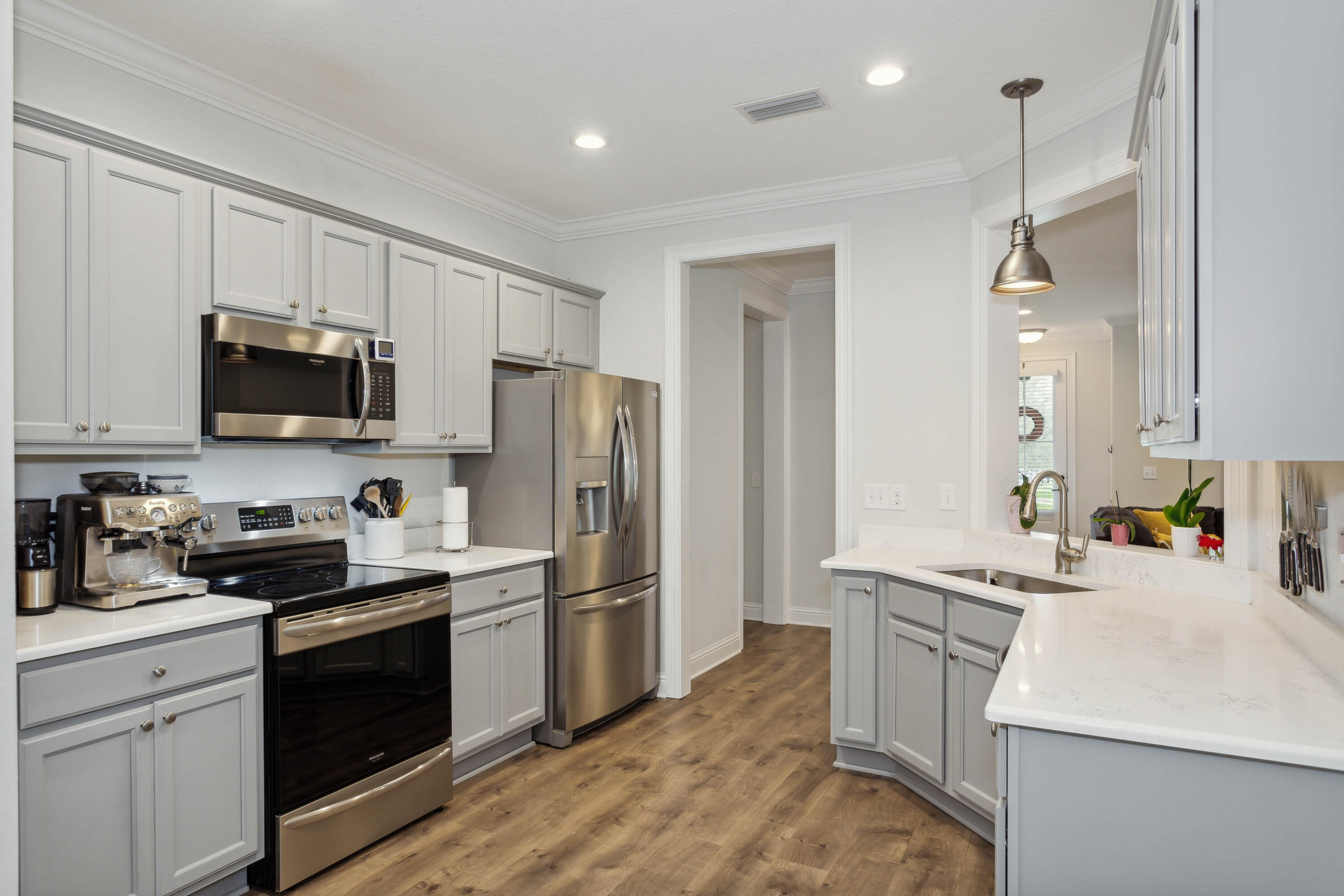 159 Laurel Oaks Drive Freeport, FL 32439 - Photo 6 of 34 a kitchen with kitchen island a sink stainless steel appliances and cabinets