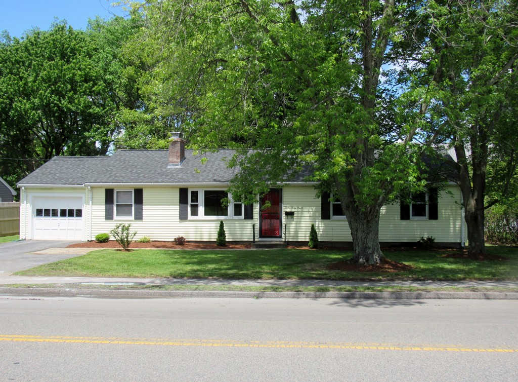1247 Trapelo Road Waltham, MA 02451 - Photo 1 of 28 a front view of a house with a yard and garage