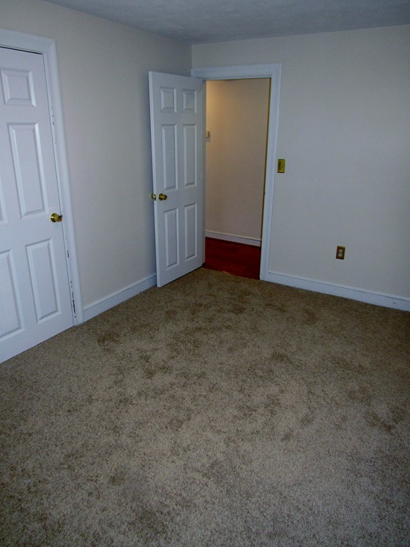 1247 Trapelo Road Waltham, MA 02451 - Photo 22 of 28 an empty room with cabinet door
