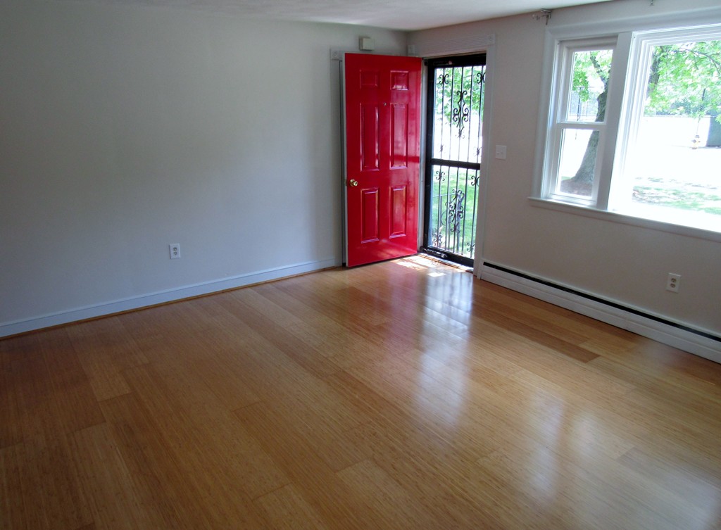 1247 Trapelo Road Waltham, MA 02451 - Photo 5 of 28 an empty room with wooden floor and windows