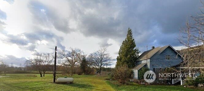 6911 Goodwin Road Everson, WA 98247 - Photo 1 of 1 a front view of a house with garden