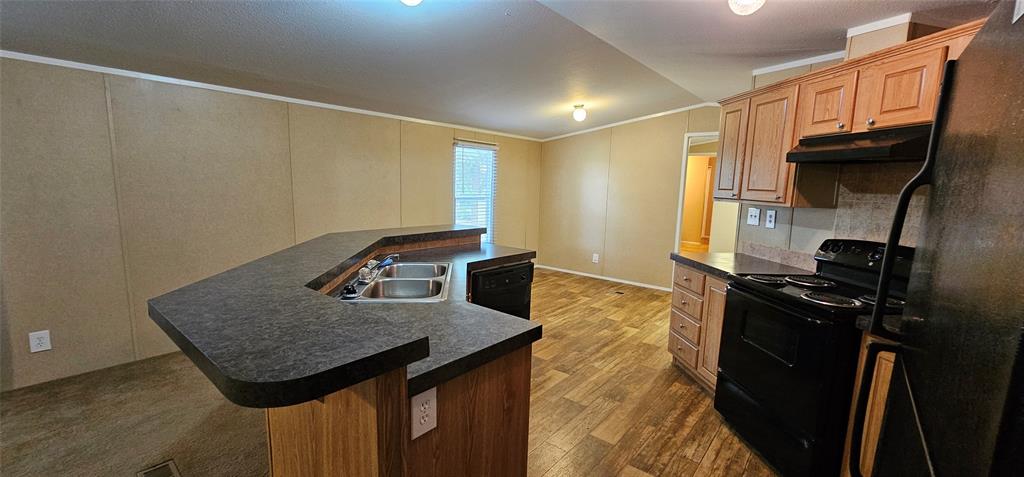 434 Geronimo Quitman, TX 75783 - Photo 13 of 36 a kitchen with a sink a stove and refrigerator